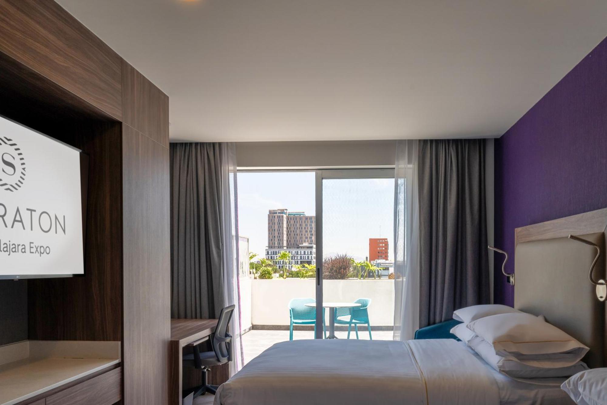 Deluxe Queen Room with Two Queen Beds and Balcony - City View