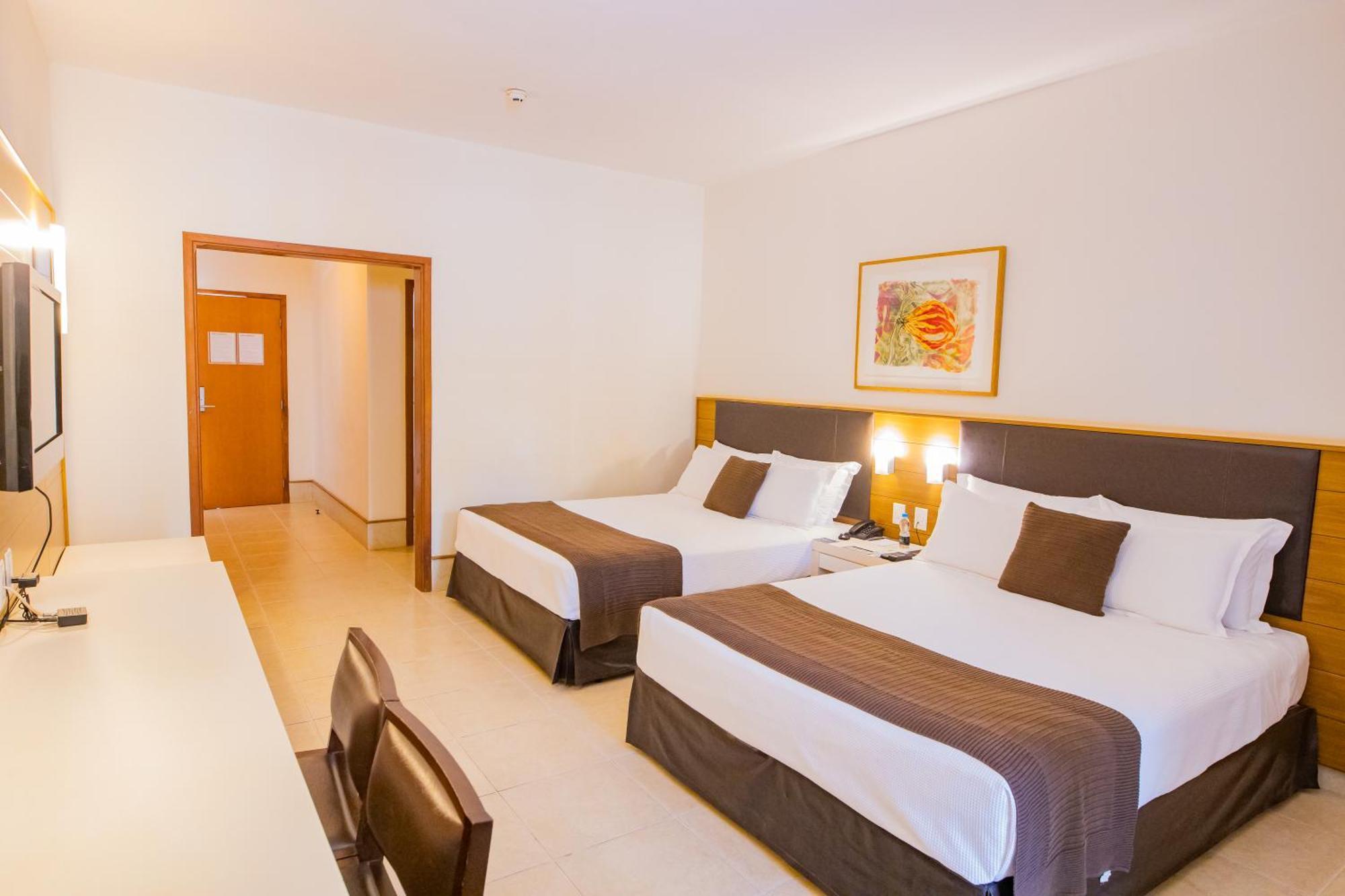 Deluxe with two double beds and pool view