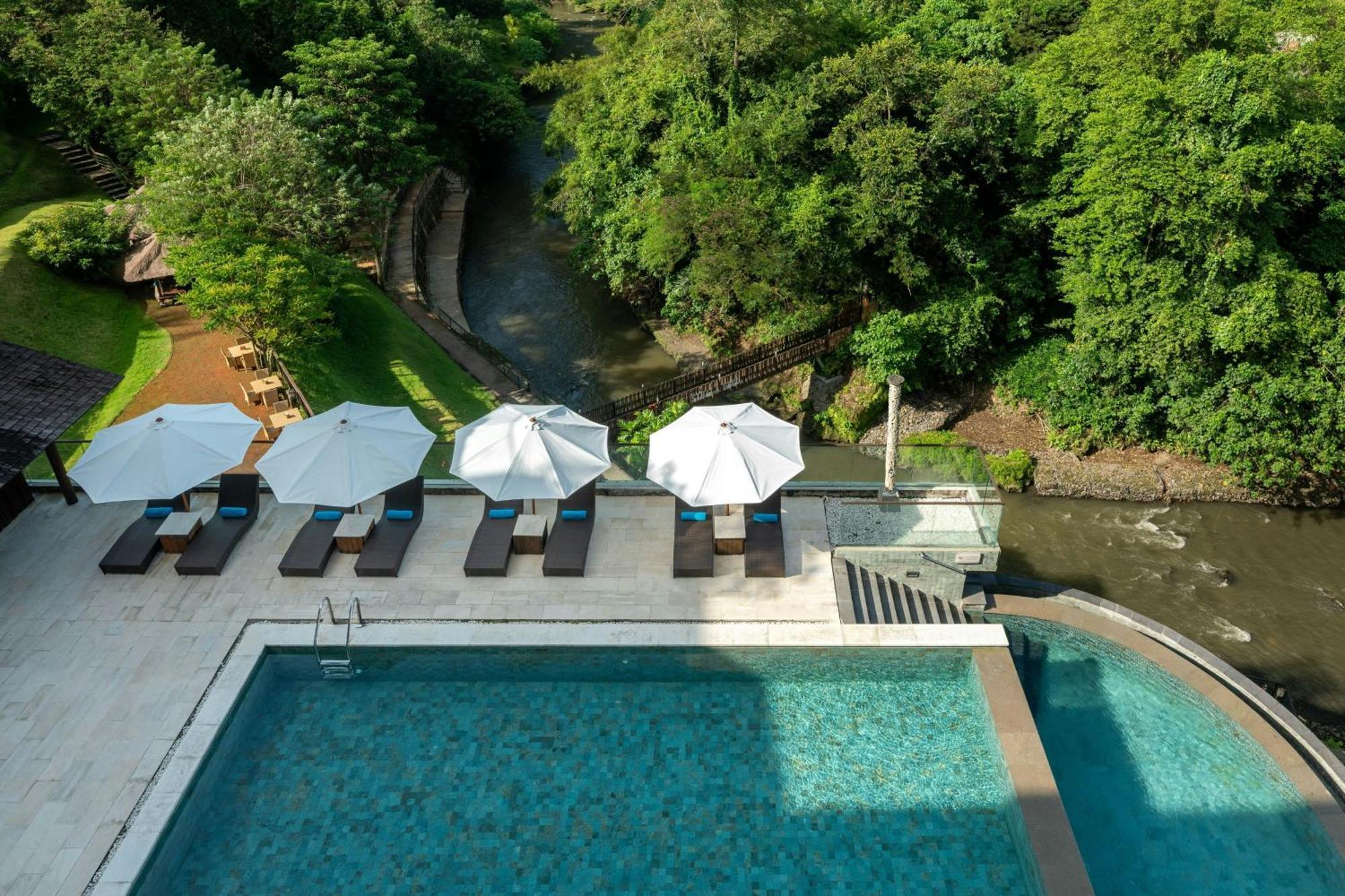 Deluxe Twin Balcony Room with River View, with FREE daily shuttle to Ubud City, FREE Photo Session, FREE Art Gallery Visit, 24-hour access to Fitness Center, FREE Welcome Drink, and FREE Kids Activities.